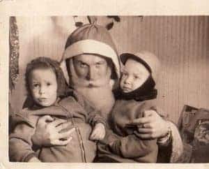 black and white creepy shot of father christmas with two kids