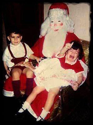 little girl crying on santa's lap with little boy sitting next to her