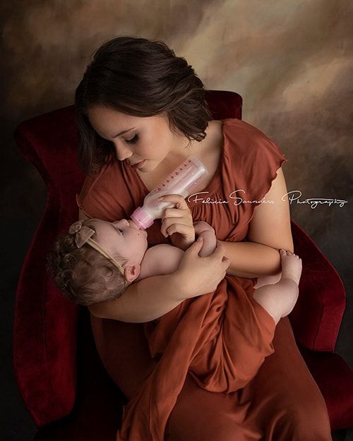 mother bottle feeding her baby formula