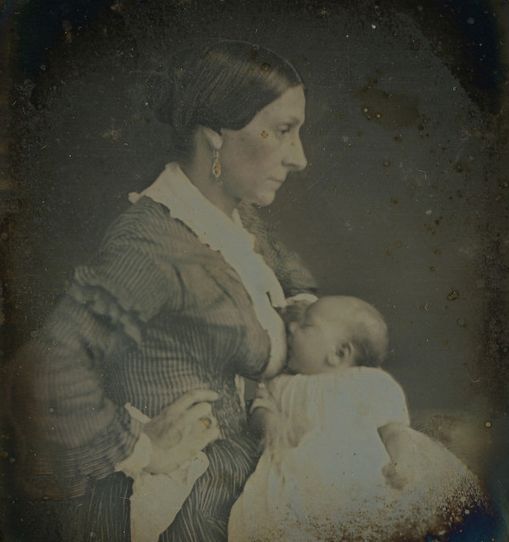 Black and white photo with profile of mother breastfeeding baby