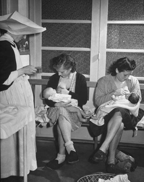 Black and white photograph of mother breastfeeding baby