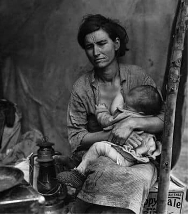 Black and white photograph of mother breastfeeding baby