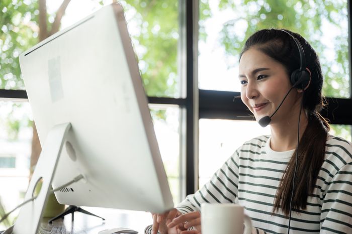 woman with headset working from home as a customer service rep