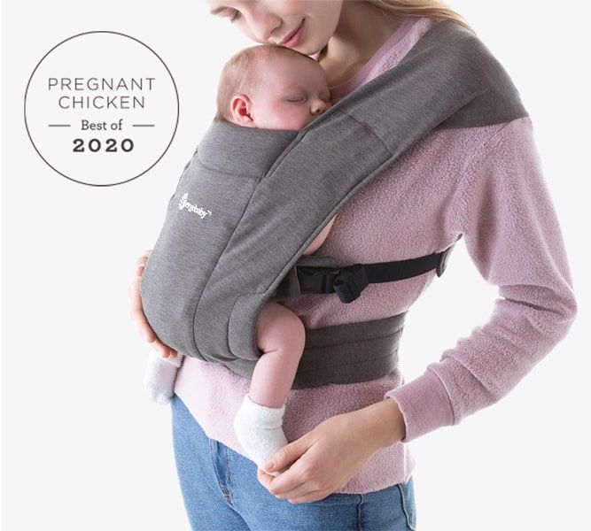 mom holding newborn baby in an Ergobaby Embrace