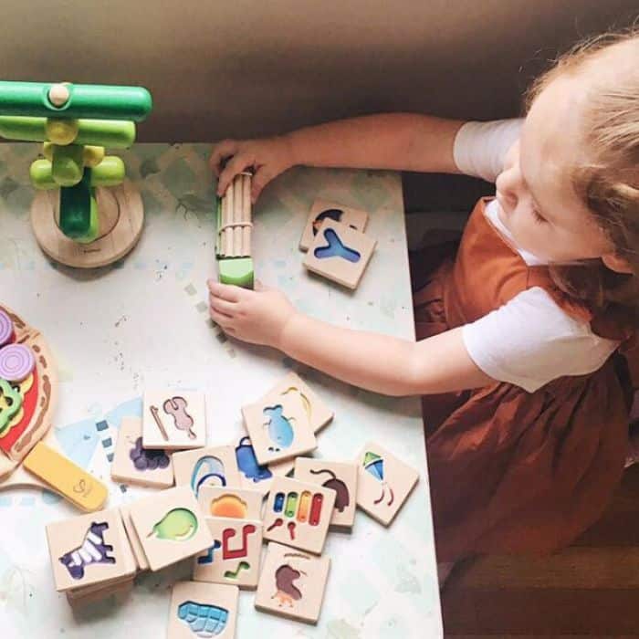 Child playing with toys from Green Piñata toy subscription box