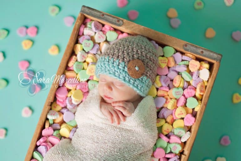 Newborn sleeping in box of Sweat Hearts