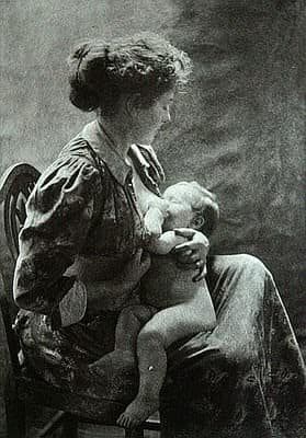 Black and white photograph of mother breastfeeding baby