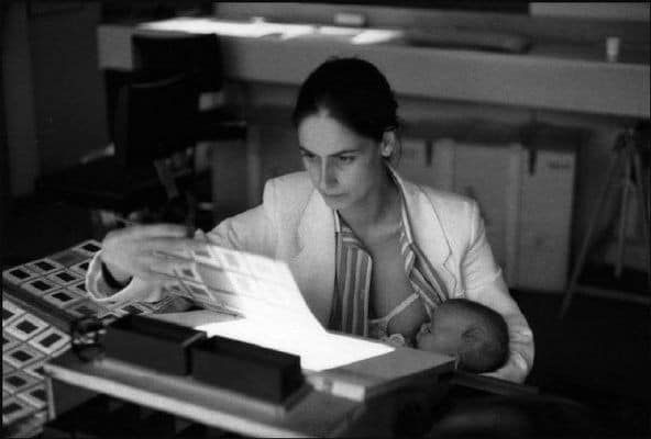 Black and white photograph of mother breastfeeding baby