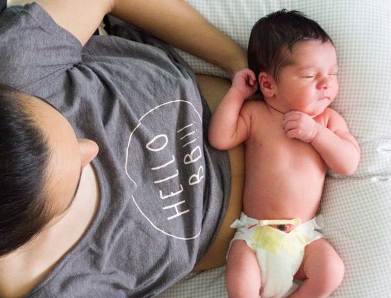 mom holding new baby on her lap