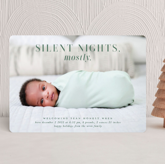 baby wrapped up on card saying silent nights mostly