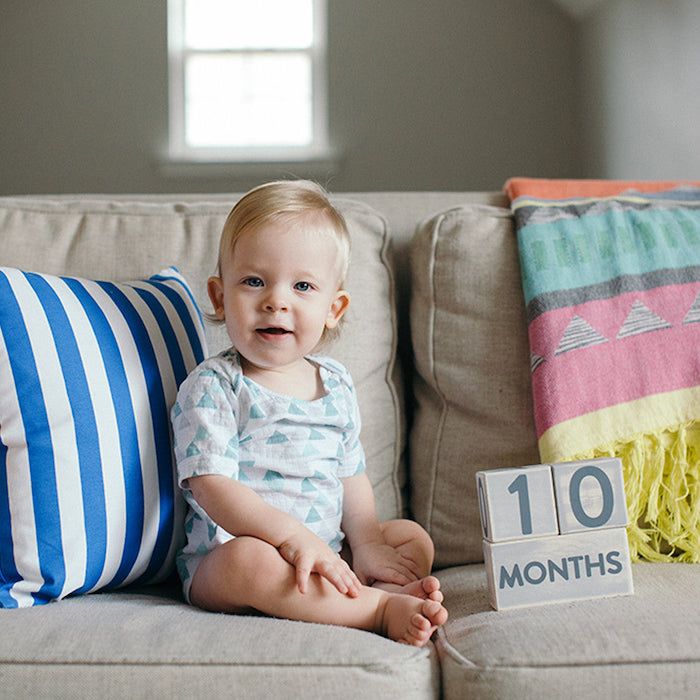 baby next to milestone blocks that say 10 months