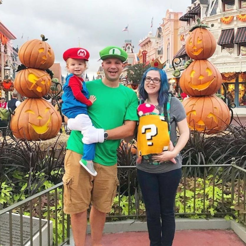 super mario family costume while baby wearing