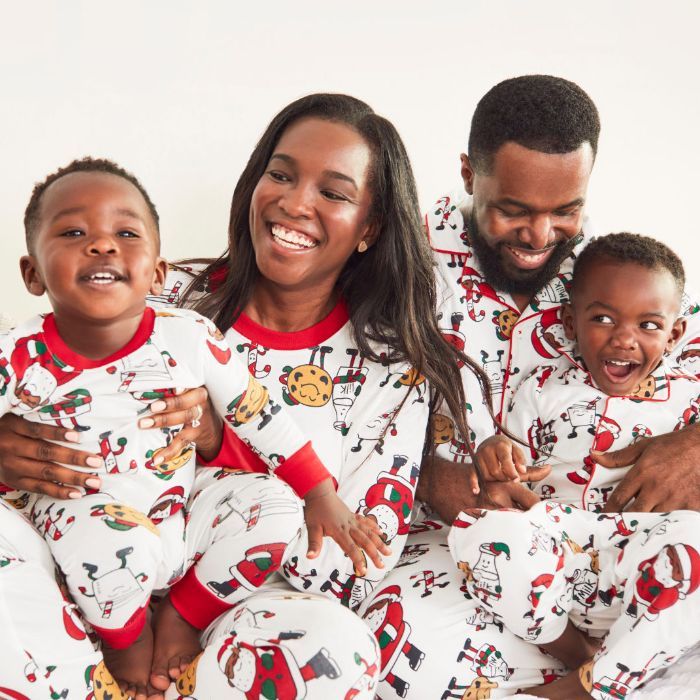 mom and dad with two little boys wearing santa milk and cookies mathcing pajamas