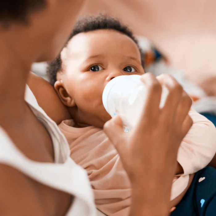 mom feeding here baby a bottle of baby's only organic premium infant formula