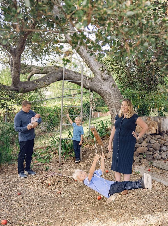 Family playing outside active big brothers dad holding newborn baby