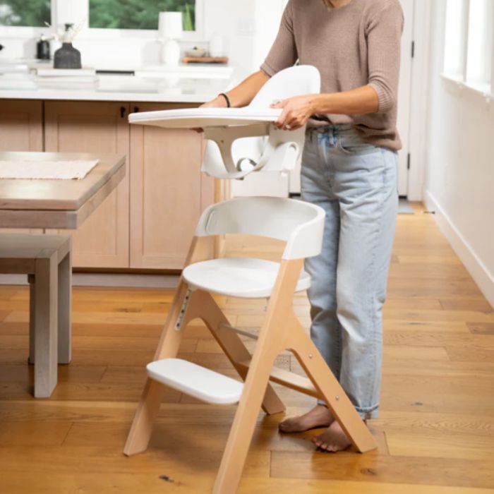 mom lifting the baby seat off the mockingbird high chair