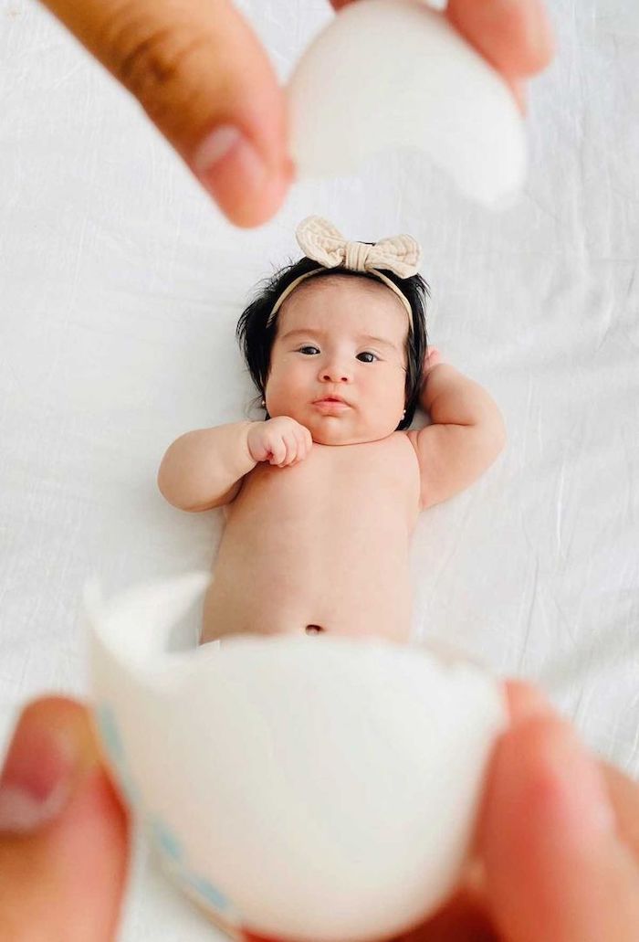 Baby's first Easter perspective photo baby between cracked egg shells